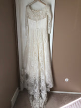 Load image into Gallery viewer, Oleg Cassini &#39;Off Shoulder Lace&#39; size 10 used wedding dress back view on hanger
