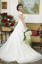 Load image into Gallery viewer, Oleg Cassini &#39;Lace Champagne&#39; size 2 used wedding dress side view on bride
