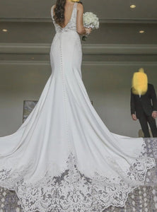 Custom 'Fit And Flare' size 2 used wedding dress back view on bride
