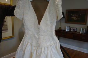 Christos 'Lace' size 4 used wedding dress back view on mannequin