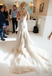 Mark Zunino 'Stunning' size 4 used wedding dress back view on bride