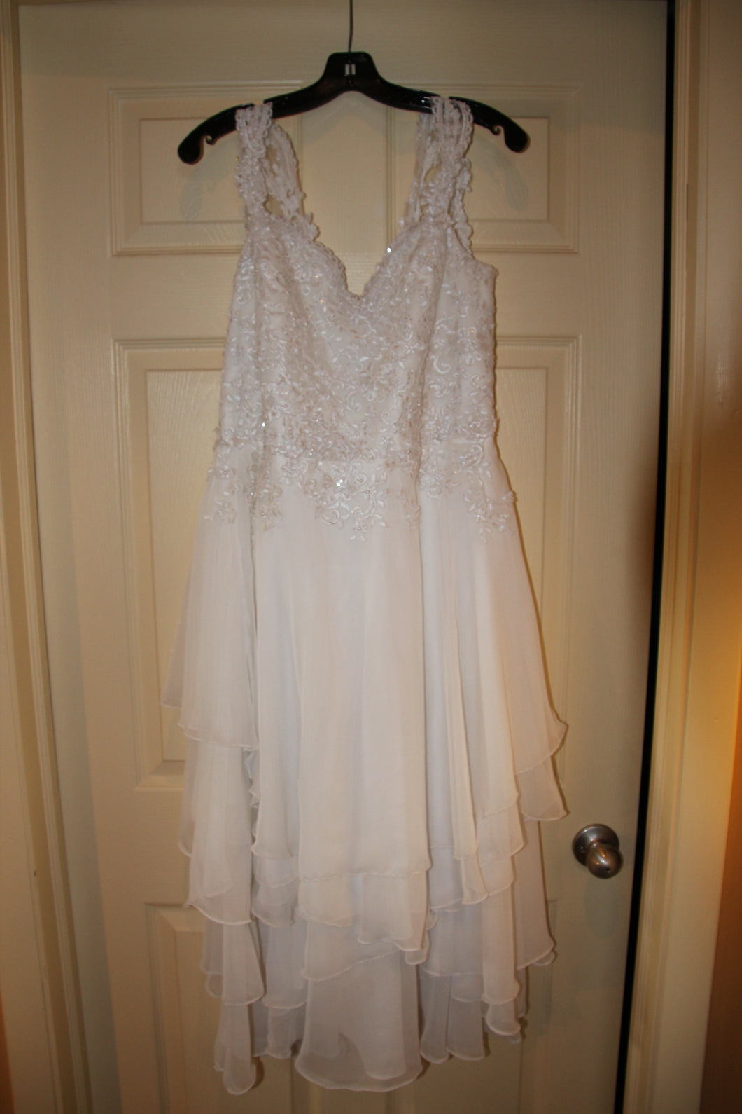 Custom 'Ivory' size 10 new wedding dress front view on hanger