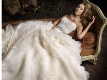 Load image into Gallery viewer, Lazaro &#39;3100&#39; size 2 used wedding dress front view on bride lying down
