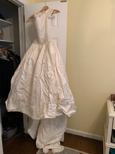 Custom 'Diamond Collection' size 8 used wedding dress front view on hanger