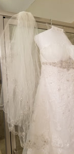 David's Bridal 'Ivory Strapless Organza' size 8 used wedding dress front view close up on hanger