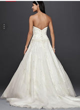 Load image into Gallery viewer, Oleg Cassini &#39;Satin Bodice Organza&#39; size 10 new wedding dress back view on model
