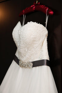 Custom 'Princess' size 16 used wedding dress side view on hanger