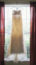 Load image into Gallery viewer, Paloma Blanca &#39;Strapless Ivory&#39; size 4 used wedding dress front view on hanger
